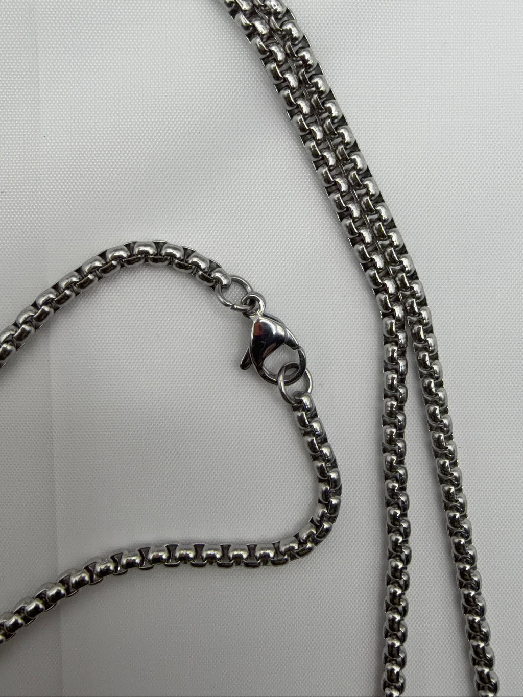 Close-up of silver box chain with lobster clasp