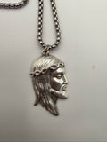Jesus pendant close-up, silver stainless steel, crown of thorns detail, made in Italy